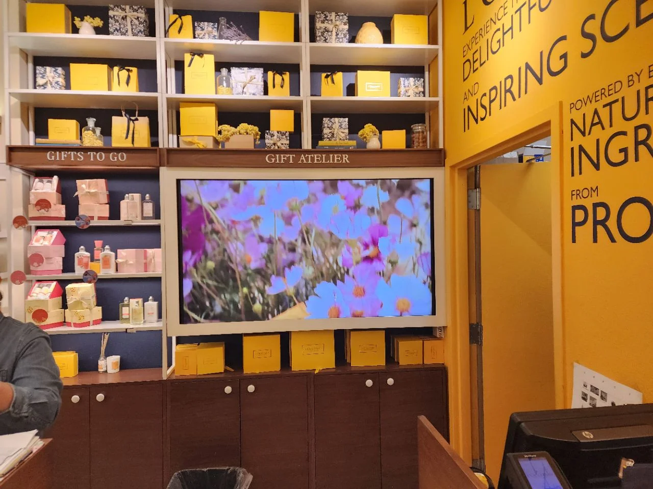 Commercial Samsung displays mounted in an L'Occitane boutique storefront window